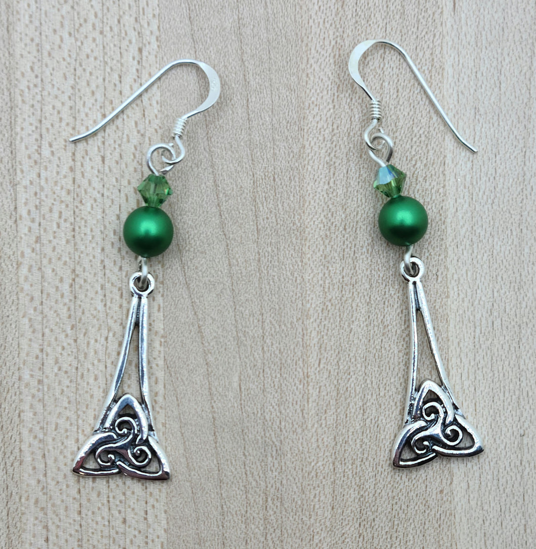 In these earrings Sterling Silver Celtic triquetra dangles hang from lovely green crystals & crystal pearls.