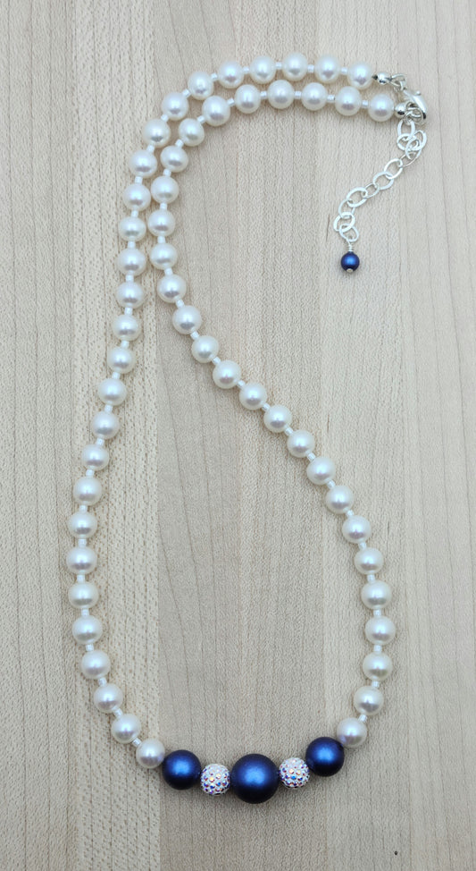 The iridescent dark blue crystal pearls & aurora borealis pave beads are exquisitely set off by white freshwater pearls in this necklace & earring set!