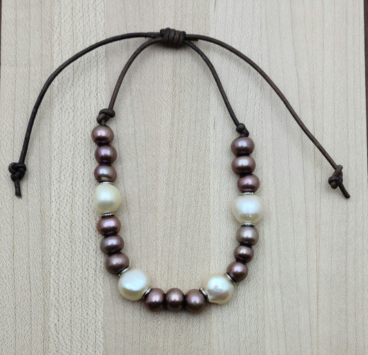 A casual leather slider bracelet of baroque freshwater in plum & cream with stainless steel rings for accent.