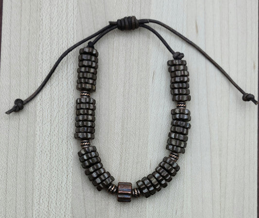 A casual leather slider bracelet of copper barrel beads and antique copper plated ceramic steampunk styled beads.
