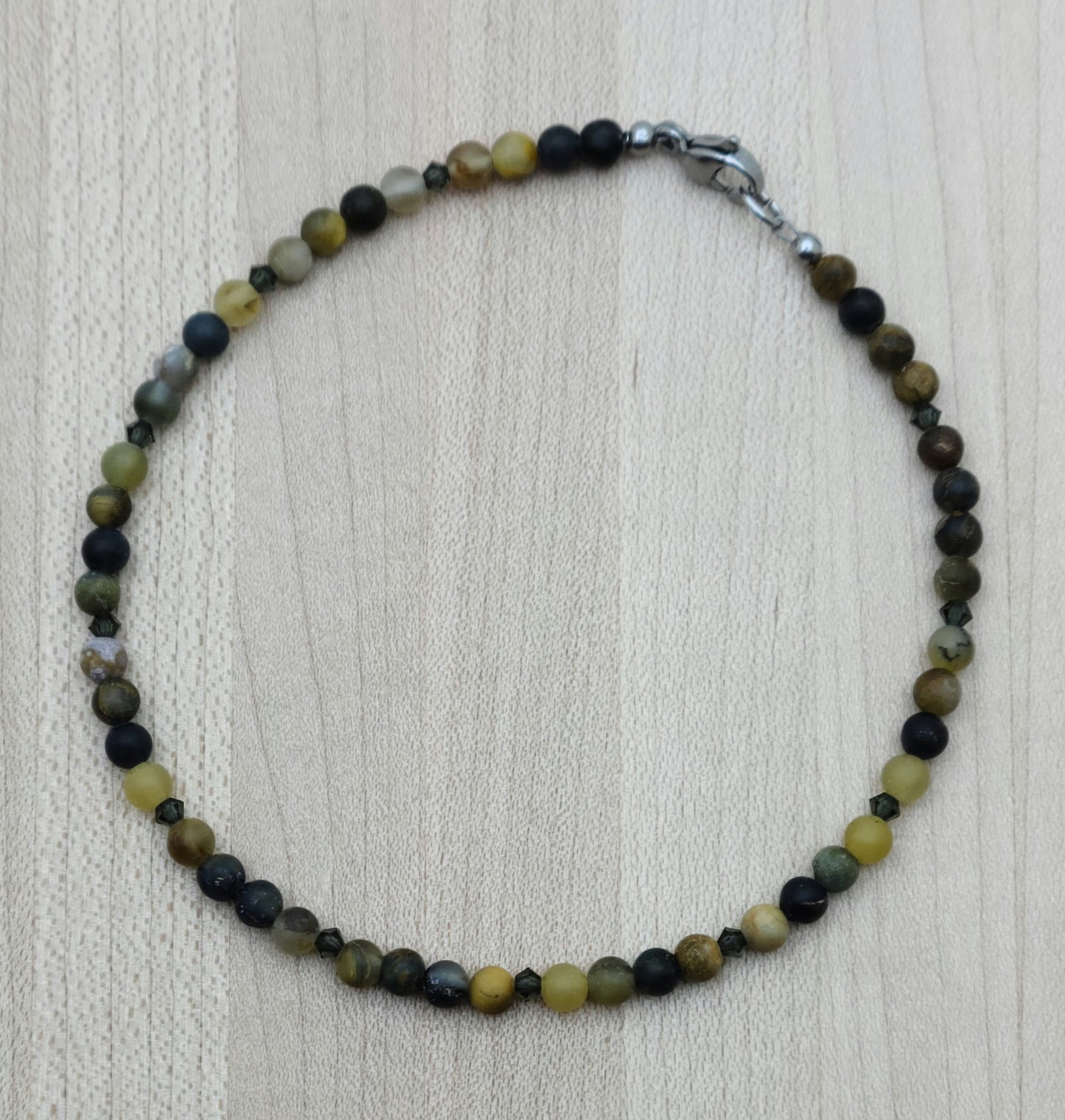 The deep golds & browns of this pietersite pair perfectly with the blackish brown of morion crystals to create a striking look to adorn your ankle!