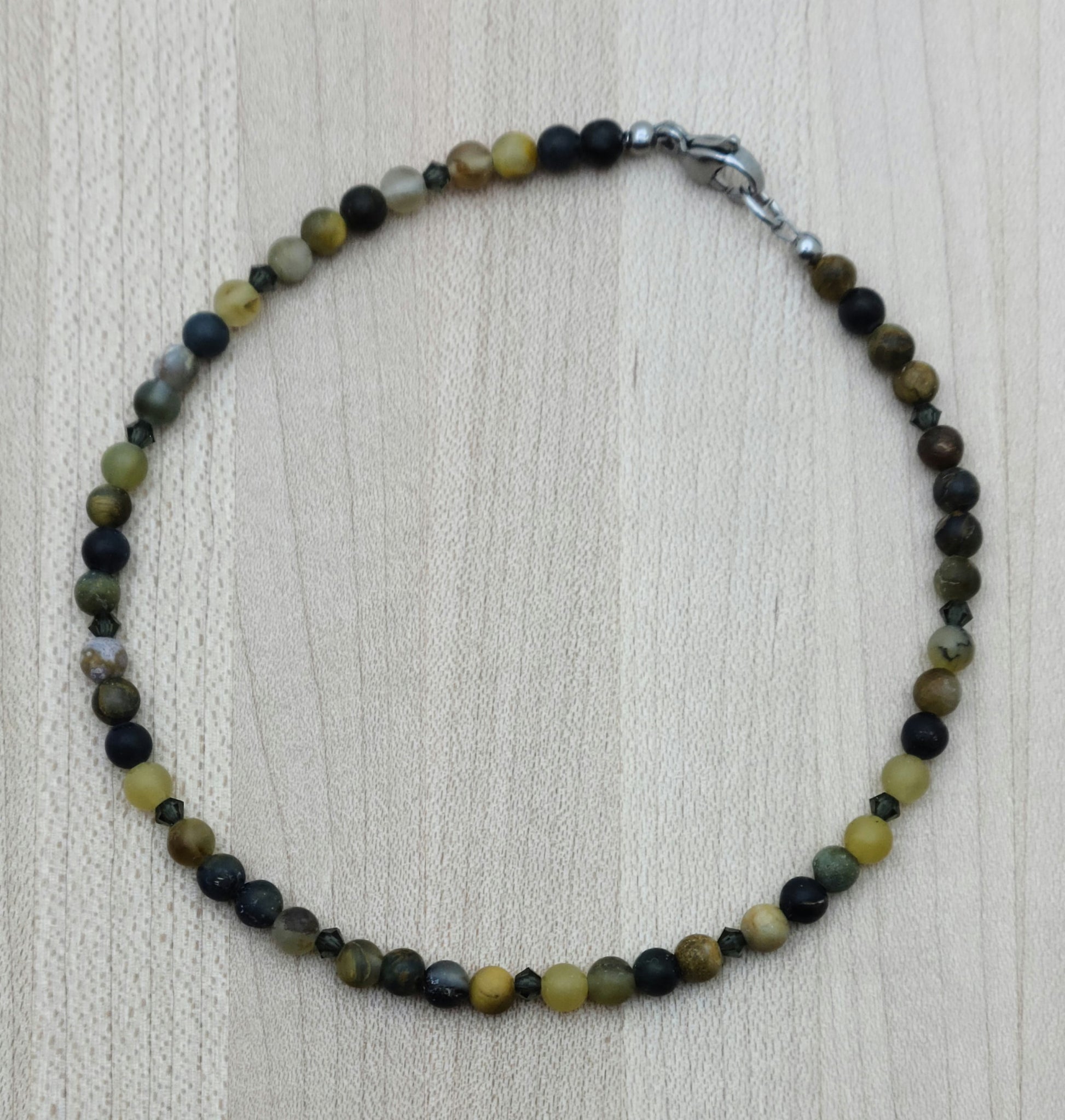The deep golds & browns of this pietersite pair perfectly with the blackish brown of morion crystals to create a striking look to adorn your ankle!