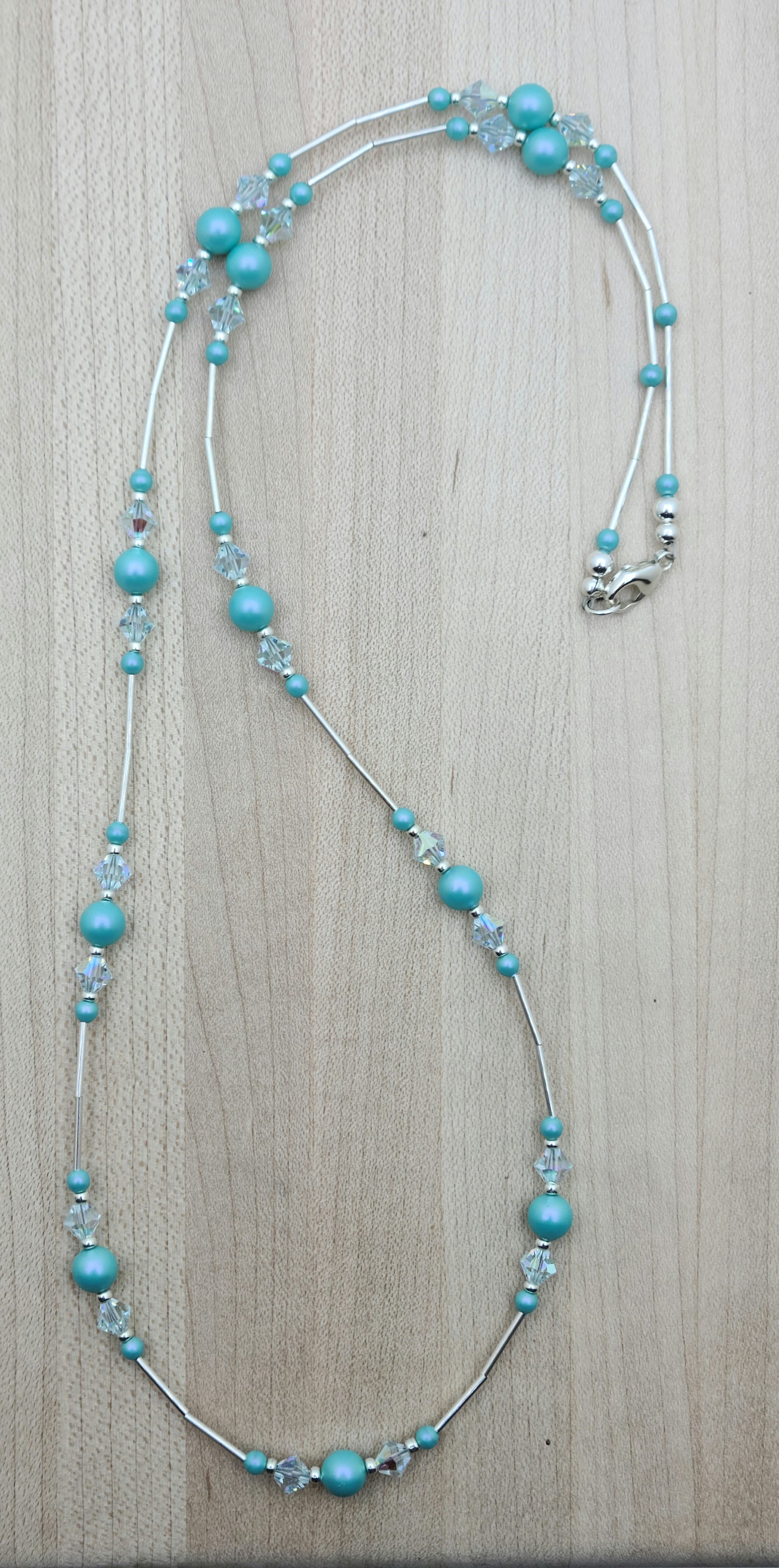 This iridescent turquoise necklace & earrings set is a gorgeous shade! Liquid argentium silver separate groups of crystal pearls & crystals!