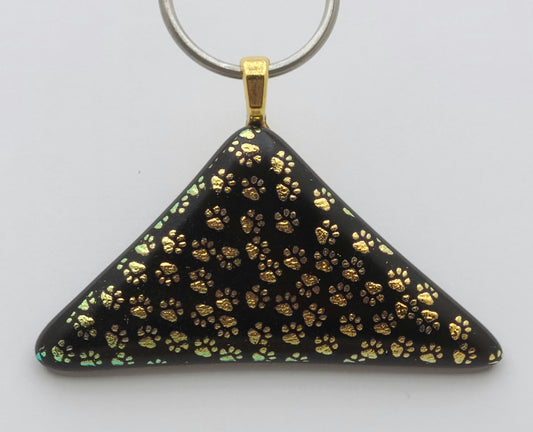 This fused glass  pendant, with its many etched dichroic paw prints, leave no doubt that you're an dog or cat lover!