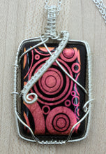 Tarnish resistant silver plated copper wire around one of my fused glass pendants of etched dichroic glass with fun red circles.