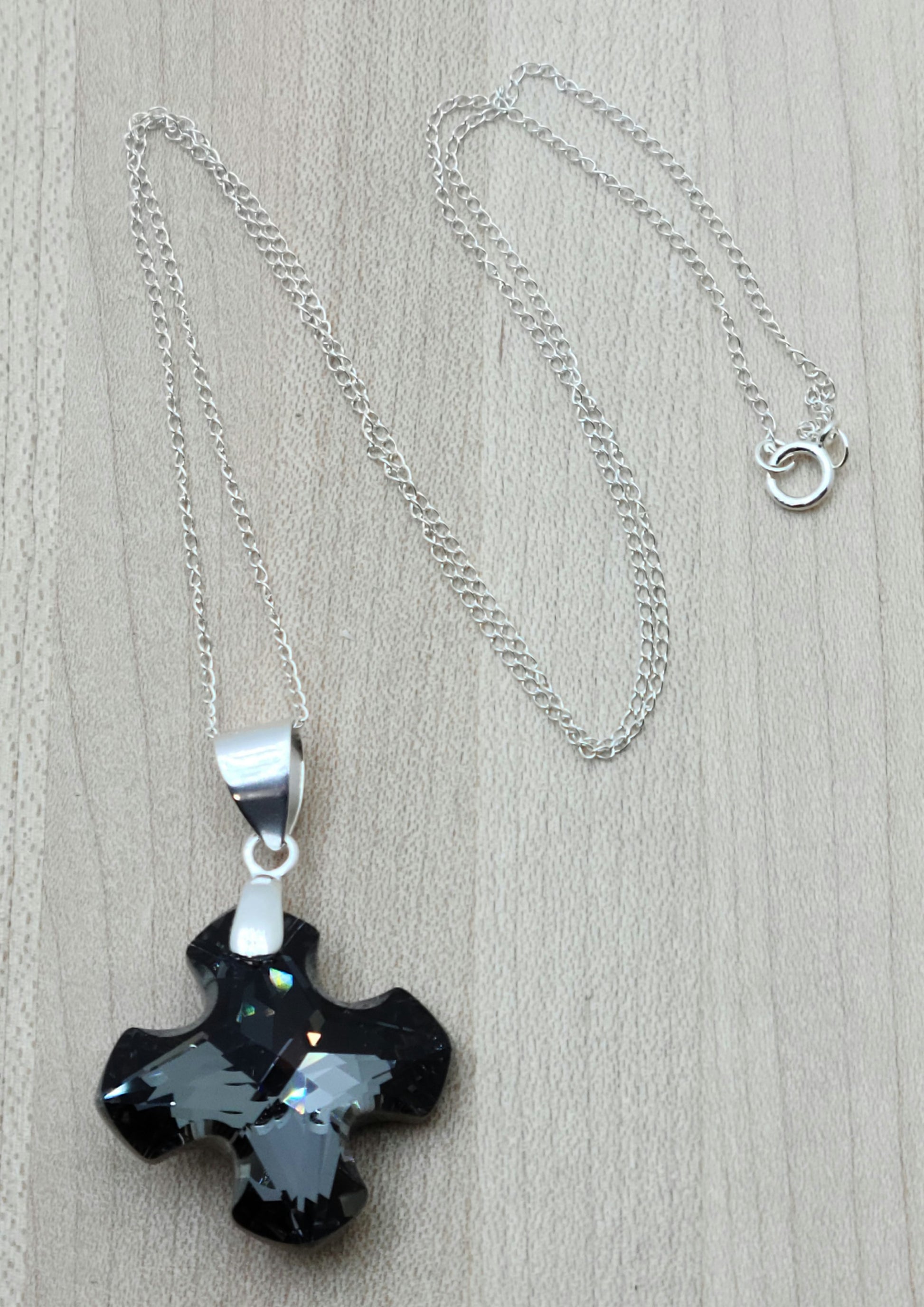 Indulge in the timeless elegance of our Crystal Greek Cross Necklace in sparkling silver night color.