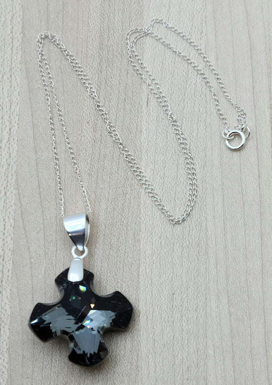 Indulge in the timeless elegance of our Crystal Greek Cross Necklace in sparkling silver night color.