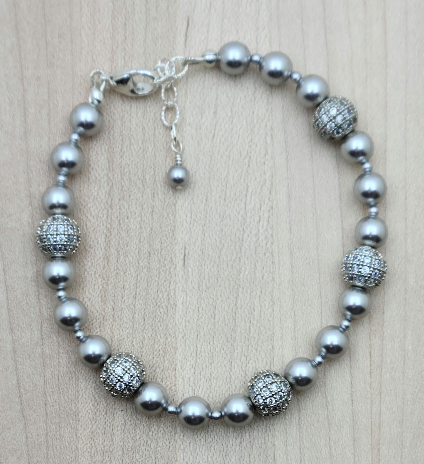 Elevate your style with our Silver CZ Shamballa Bracelet. The combination of silver crystal pearls and cubic zirconia encrusted shamballa beads creates a sophisticated look.