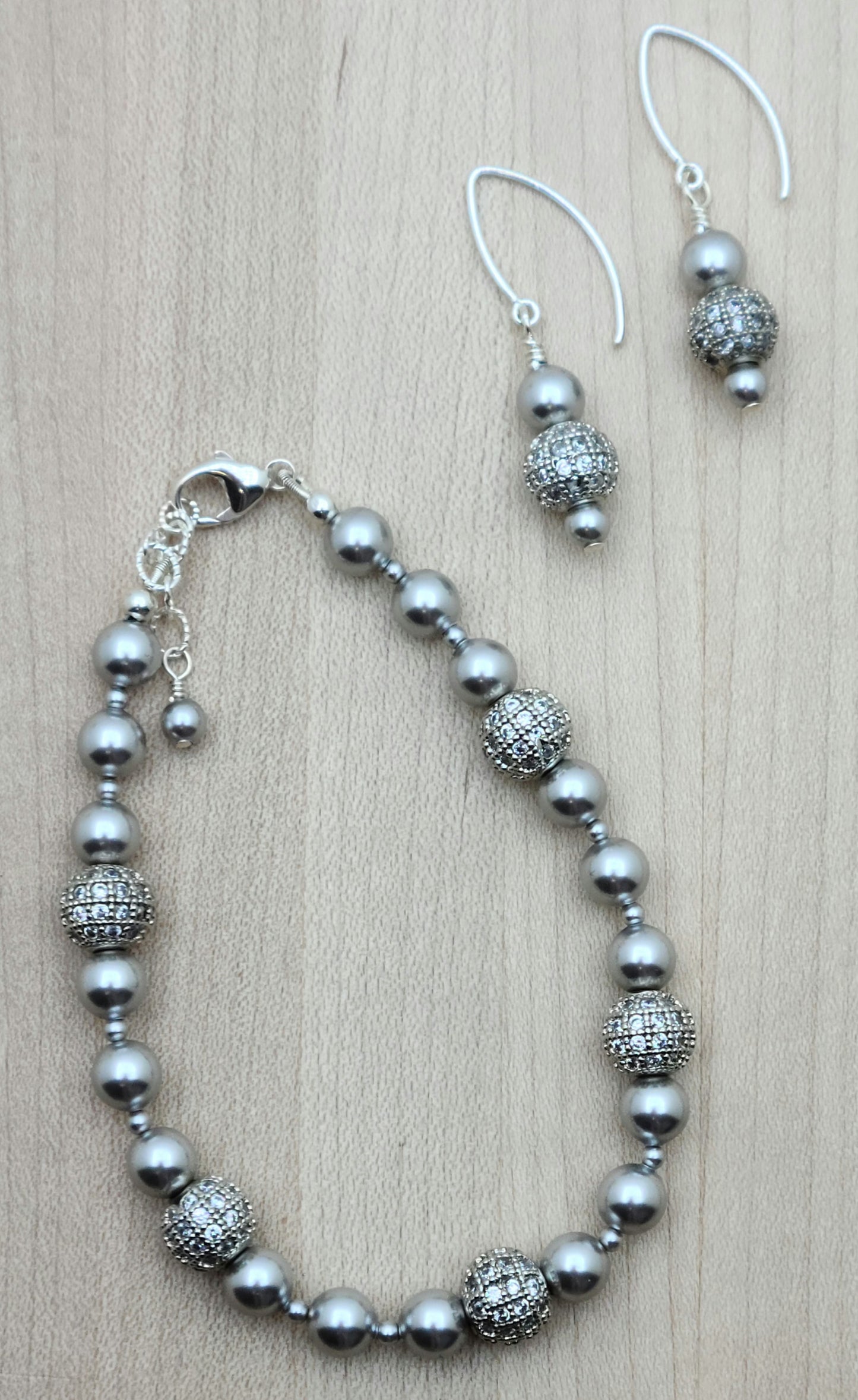 Elevate your style with our Silver CZ Shamballa Bracelet & Earrings set. The combination of silver crystal pearls and cubic zirconia encrusted shamballa beads creates a sophisticated look.