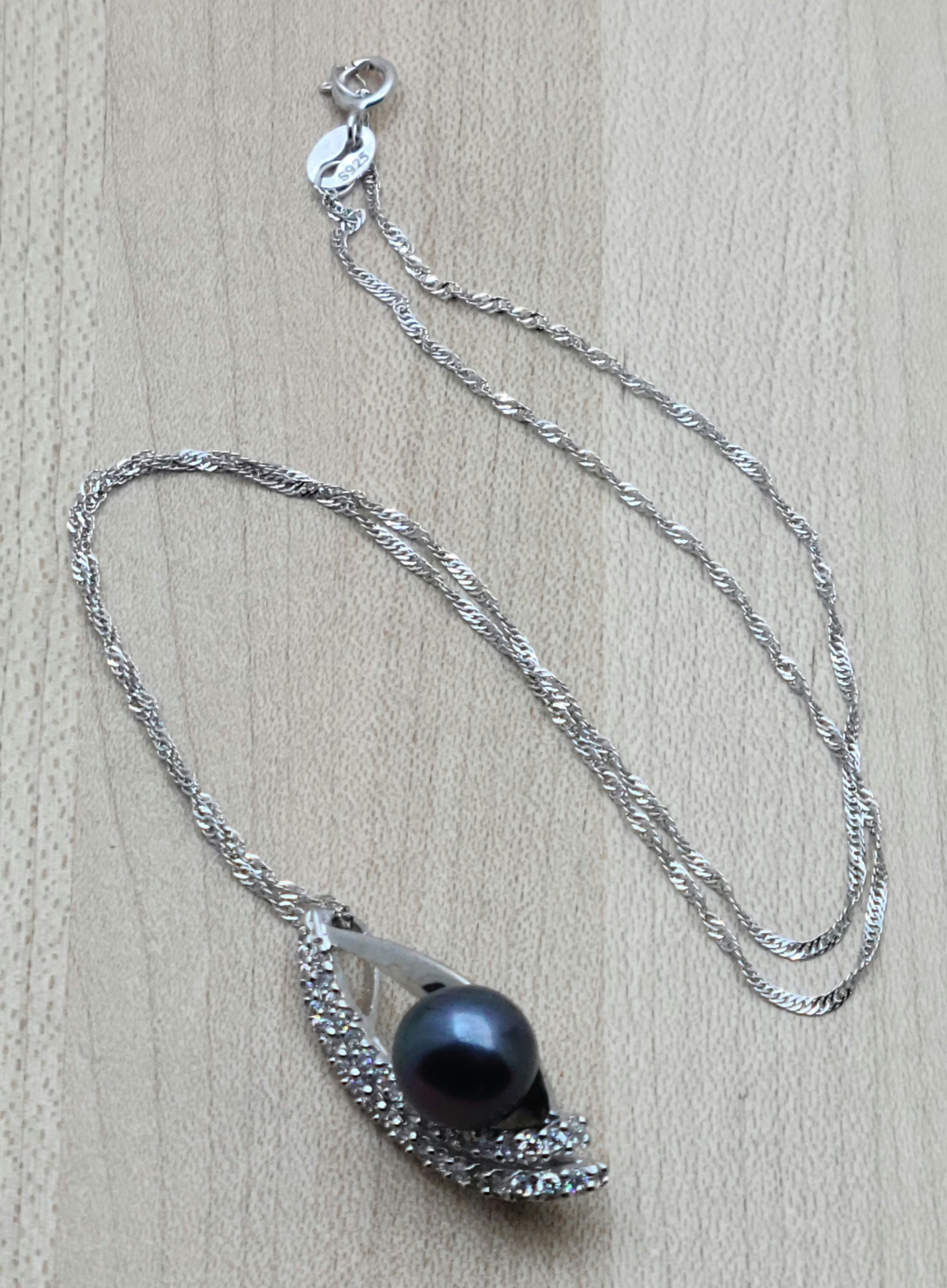 Large 'black' fw pearl mounted in a marquise shaped sterling silver and cubic zirconia setting