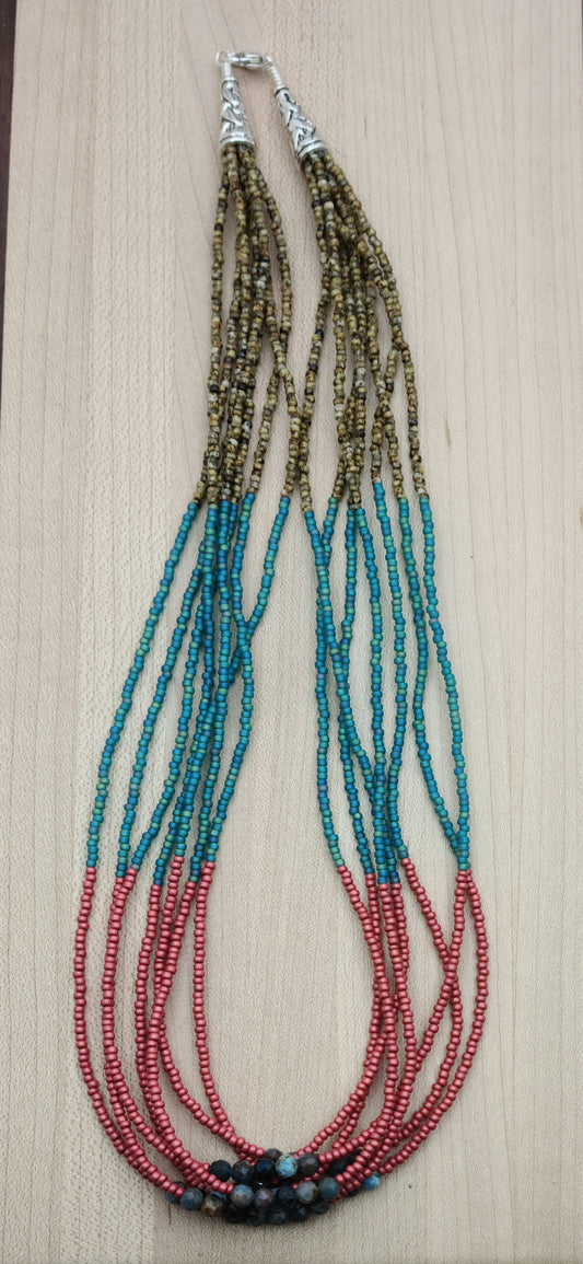 Add some earthy and playful flair to your jewelry collection with my Apatite & Seed Bead Multi-Strand Necklace in brown, turquoise, & cranberry.