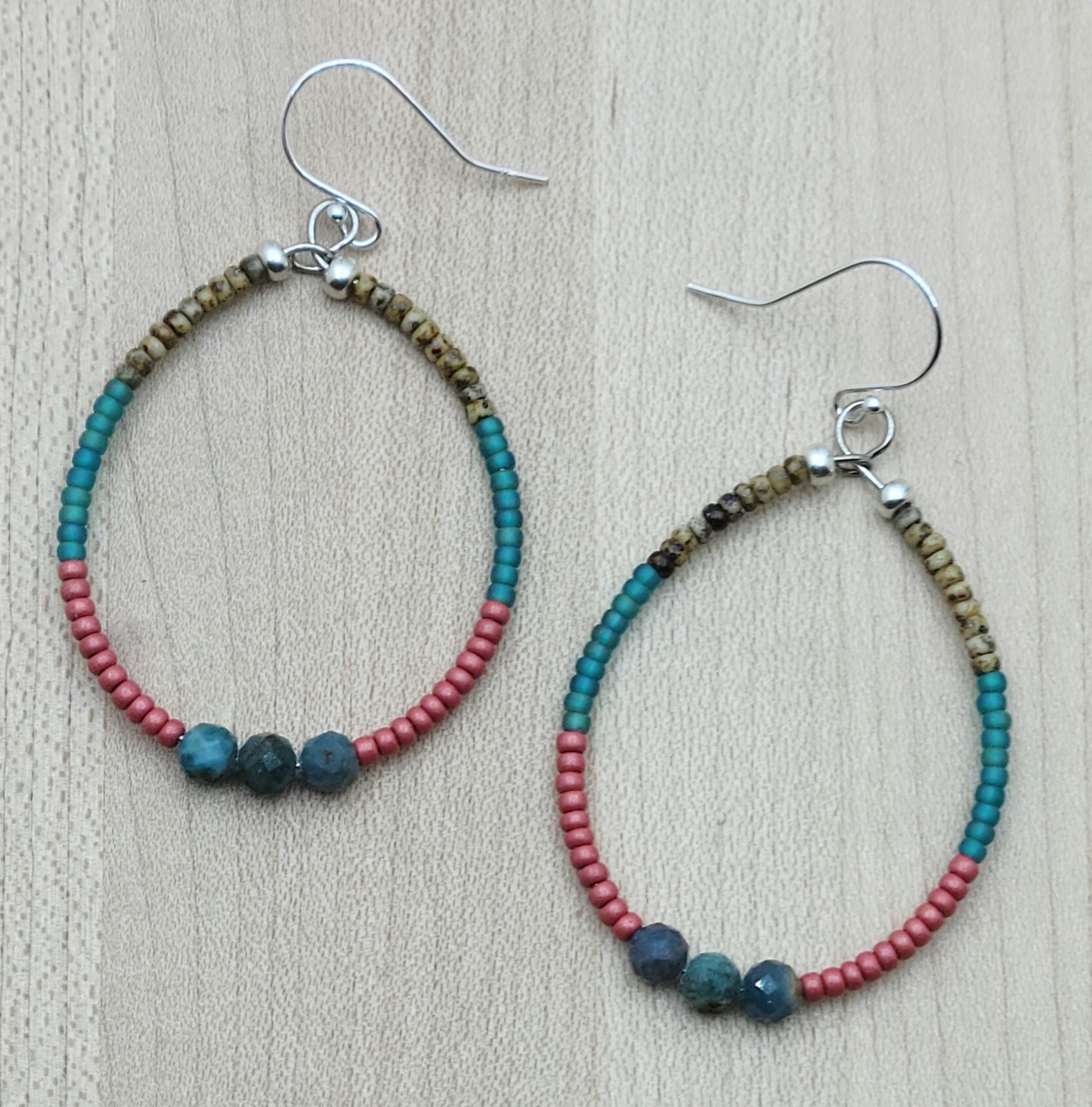 Add some earthy and playful flair to your jewelry collection with my Apatite & Seed Bead Multi-Strand Hoop Earrings in brown, turquoise, & cranberry.