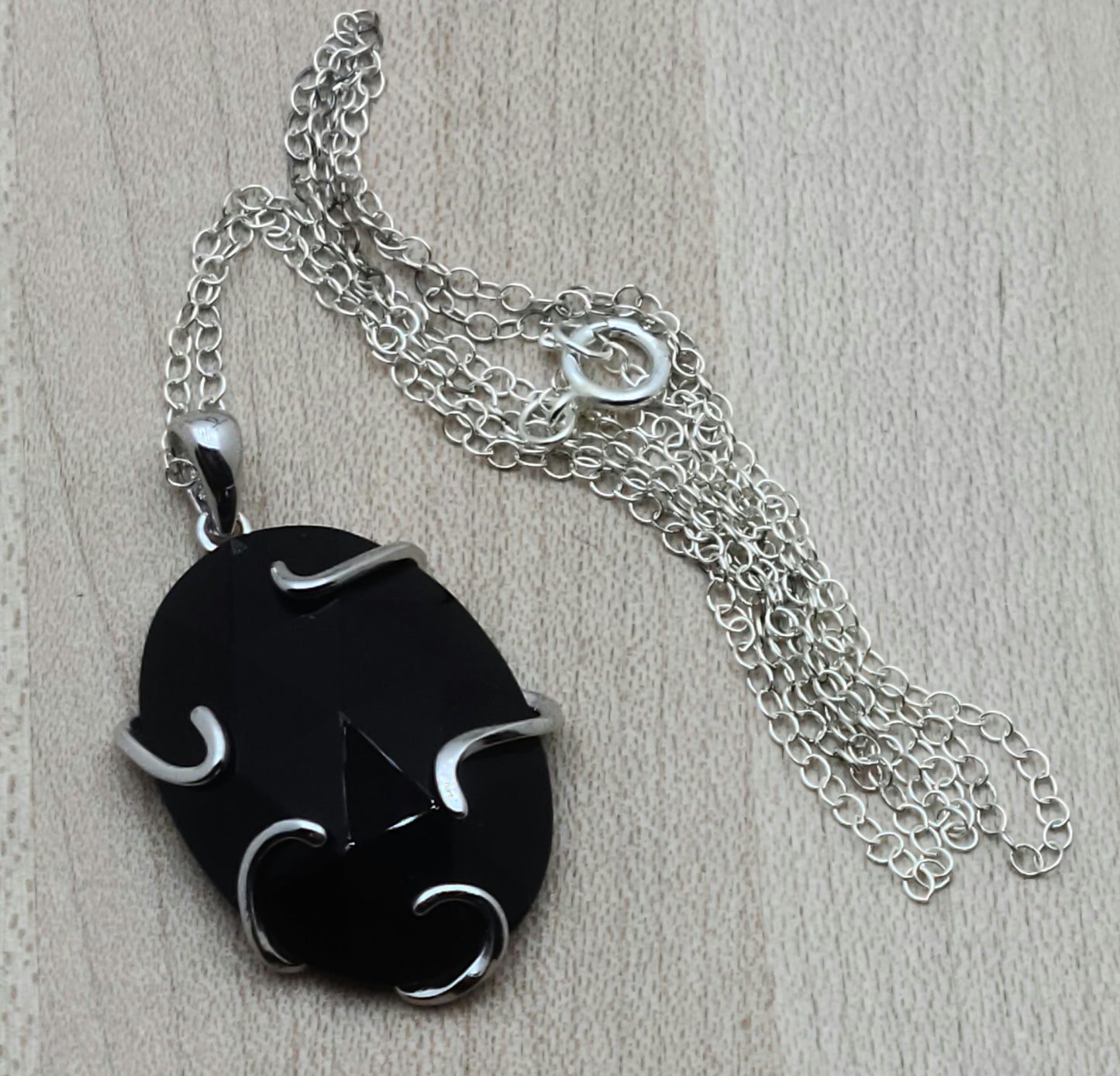 Faceted Onyx Pendant with free form sterling silver bezel & sterling silver frame