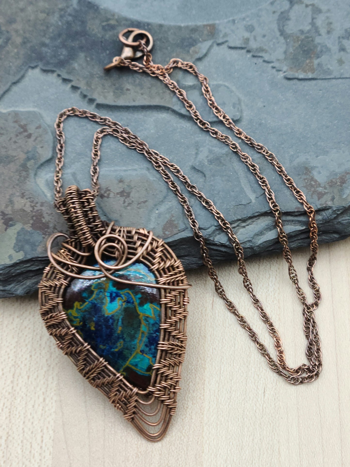 Crysocolla stone framed by antiqued copper wove wire