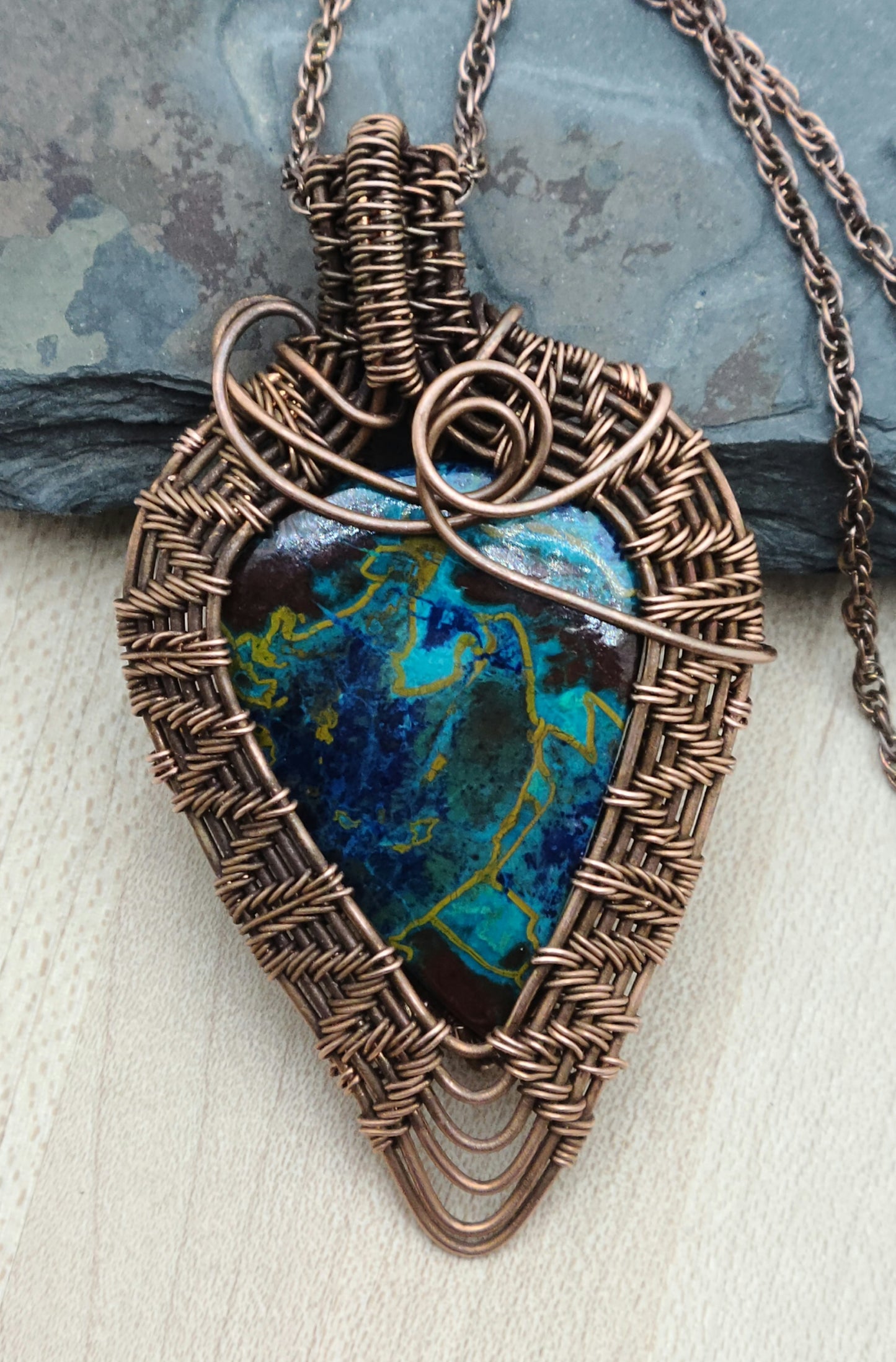 Crysocolla stone framed by antiqued copper wove wire