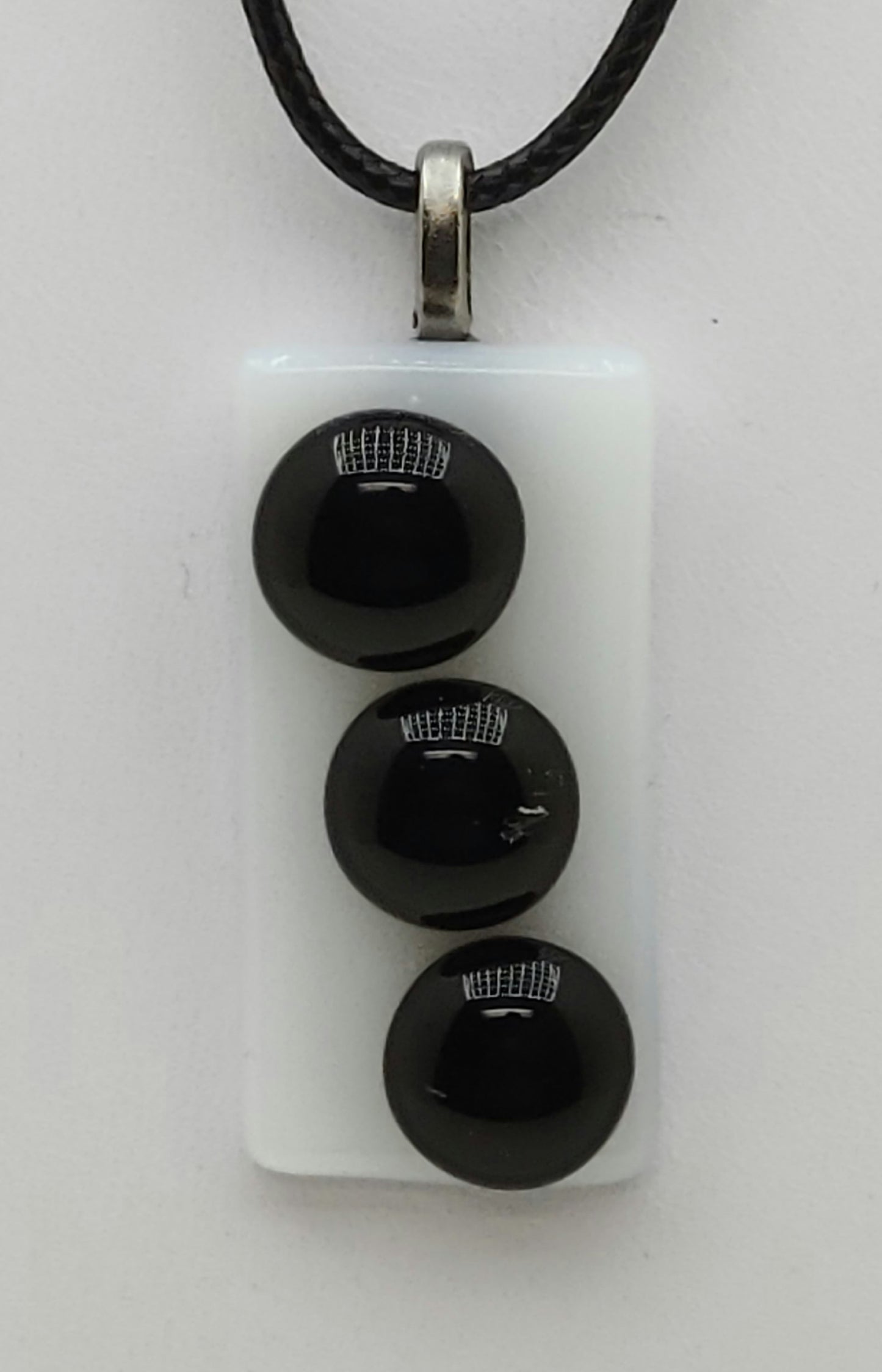 3 black buttons on white background fused glass pedant