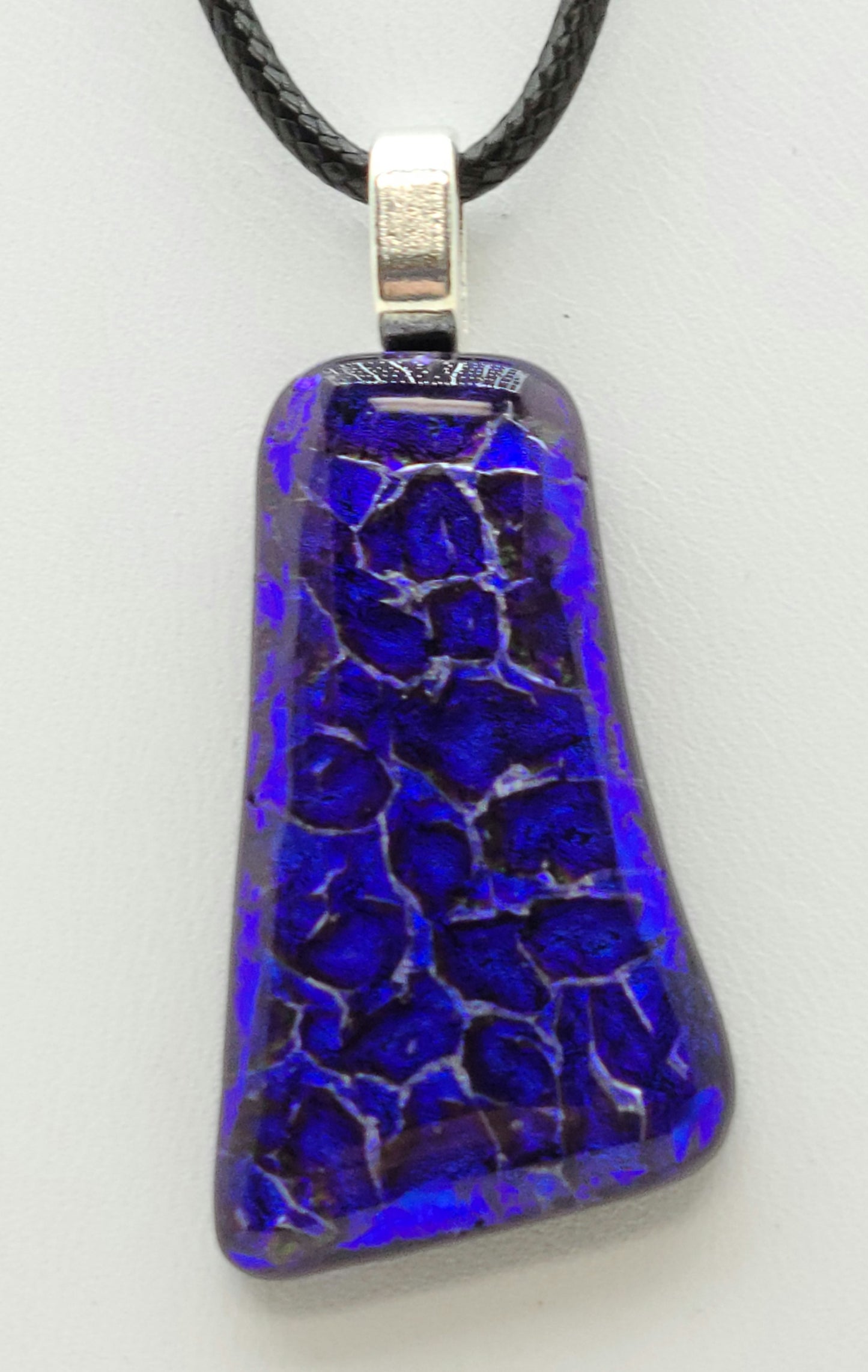 This fused glass pendant looks like purple submerged rocks!