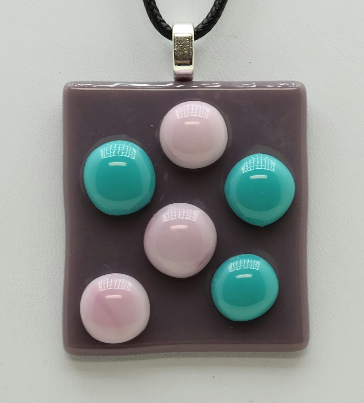 Pink & Aqua 'pebbles' adorn this lilac fused glass pendant.
