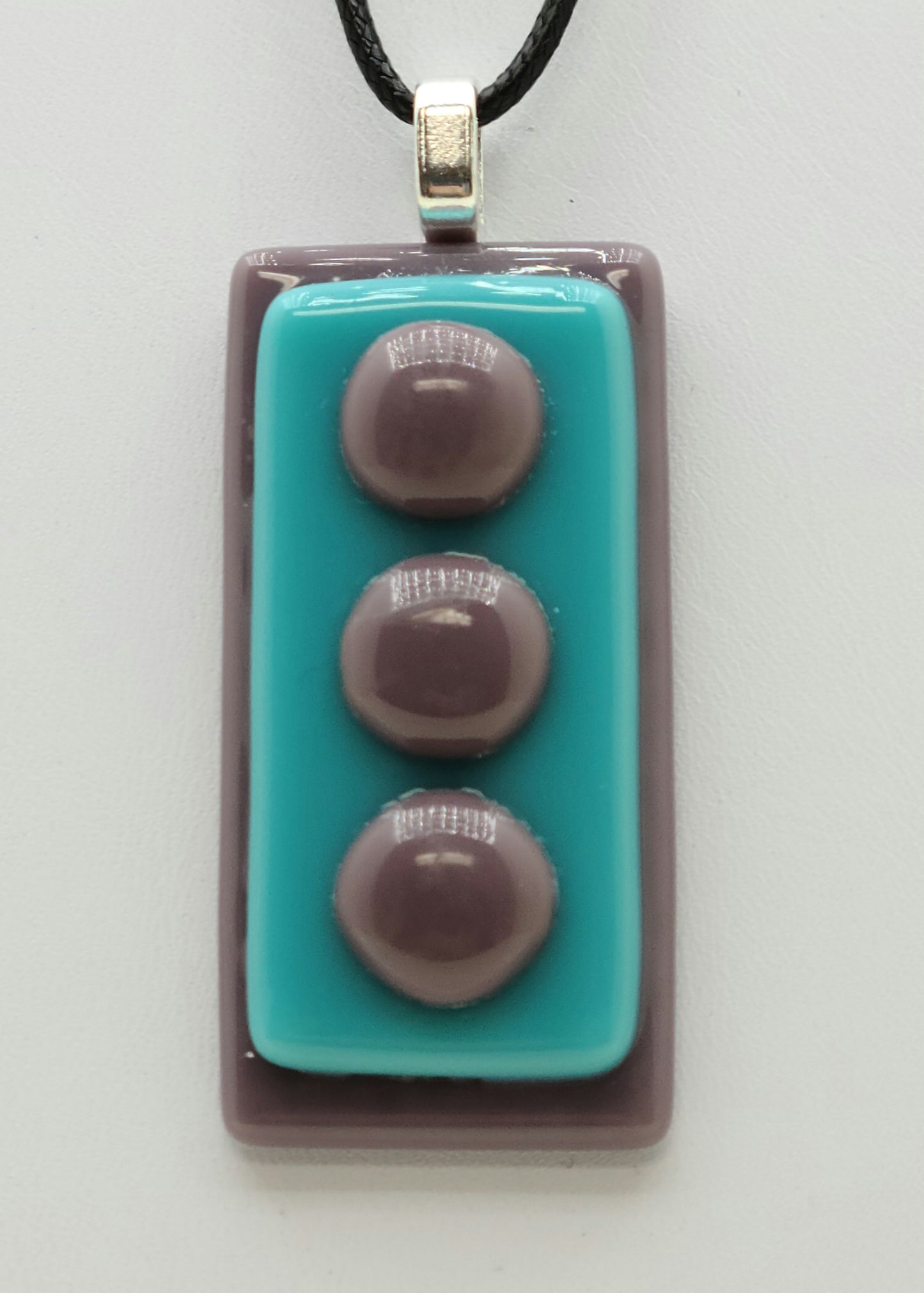 Fused glass pendant with lilac background and foreground 'pebbles' & aqua middle!