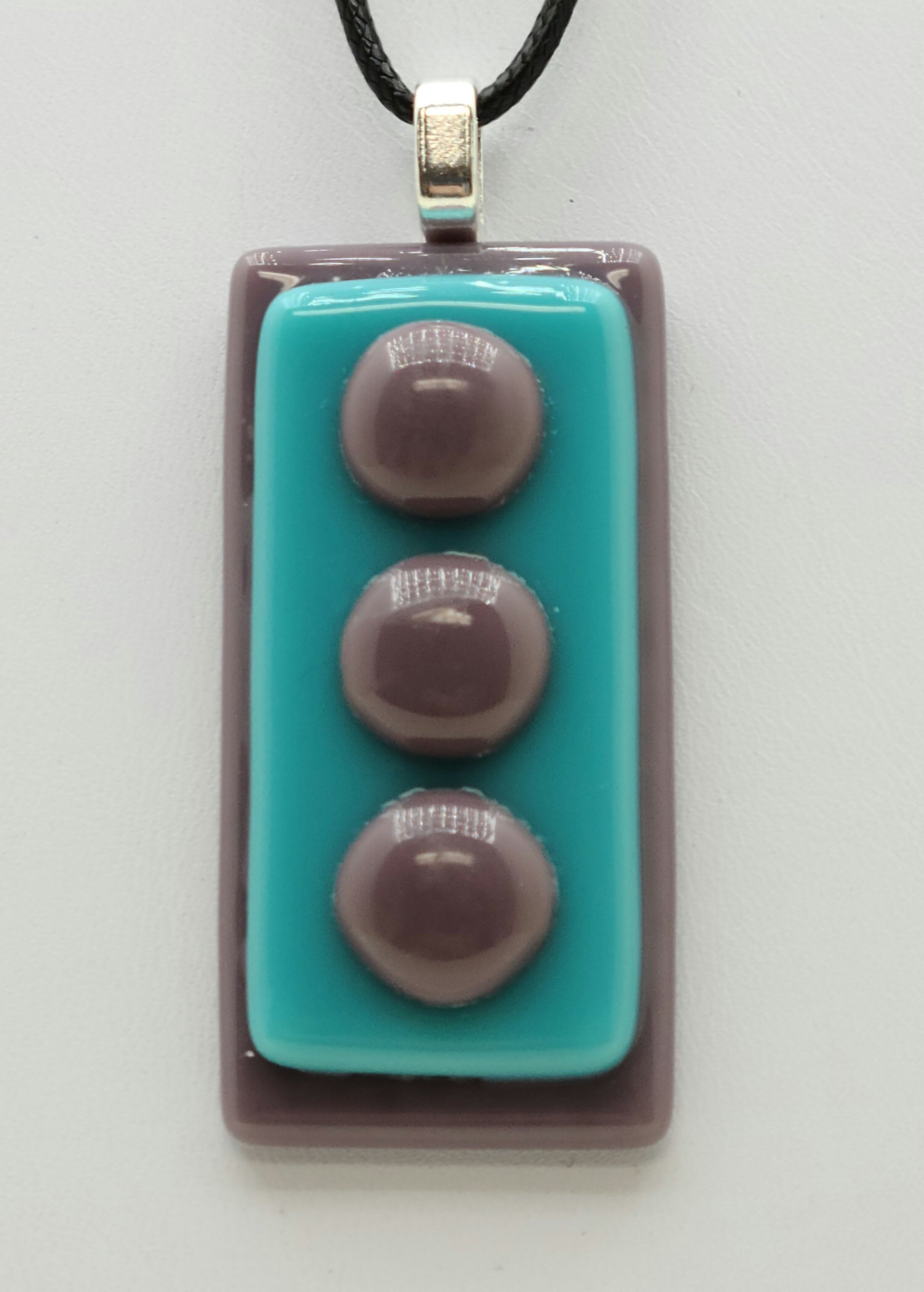 Fused glass pendant with lilac background and foreground 'pebbles' & aqua middle!