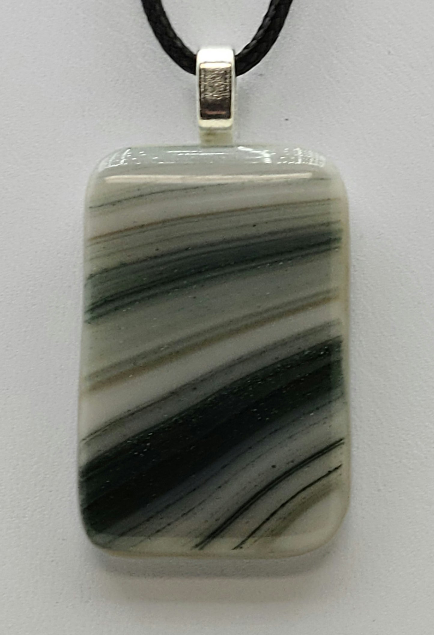 Brush strokes of glittery green adorn this fused glass pendant.