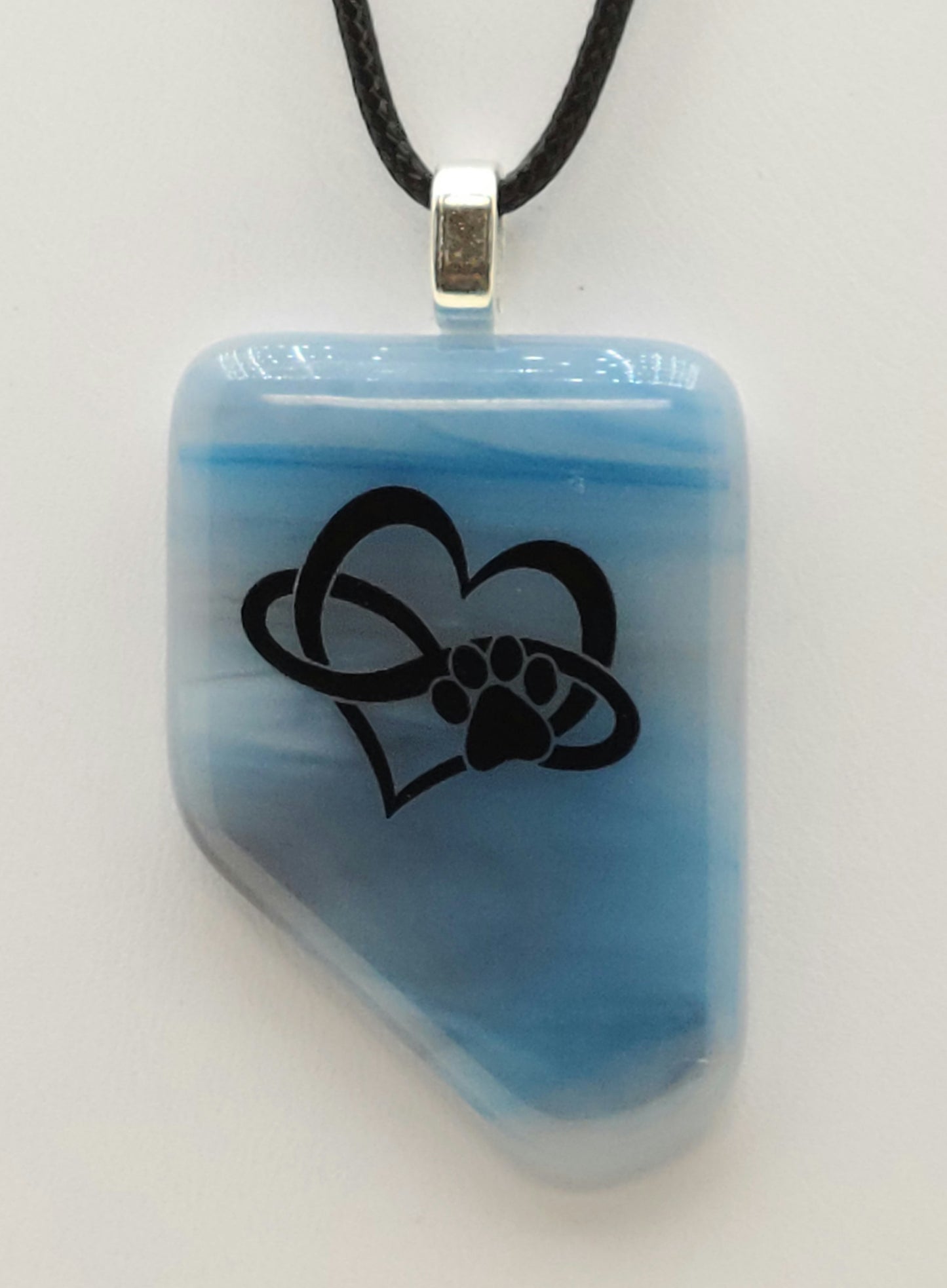 Love your pup to infinity with this heart/infinity/paw on streaky blue fused glass pendant.