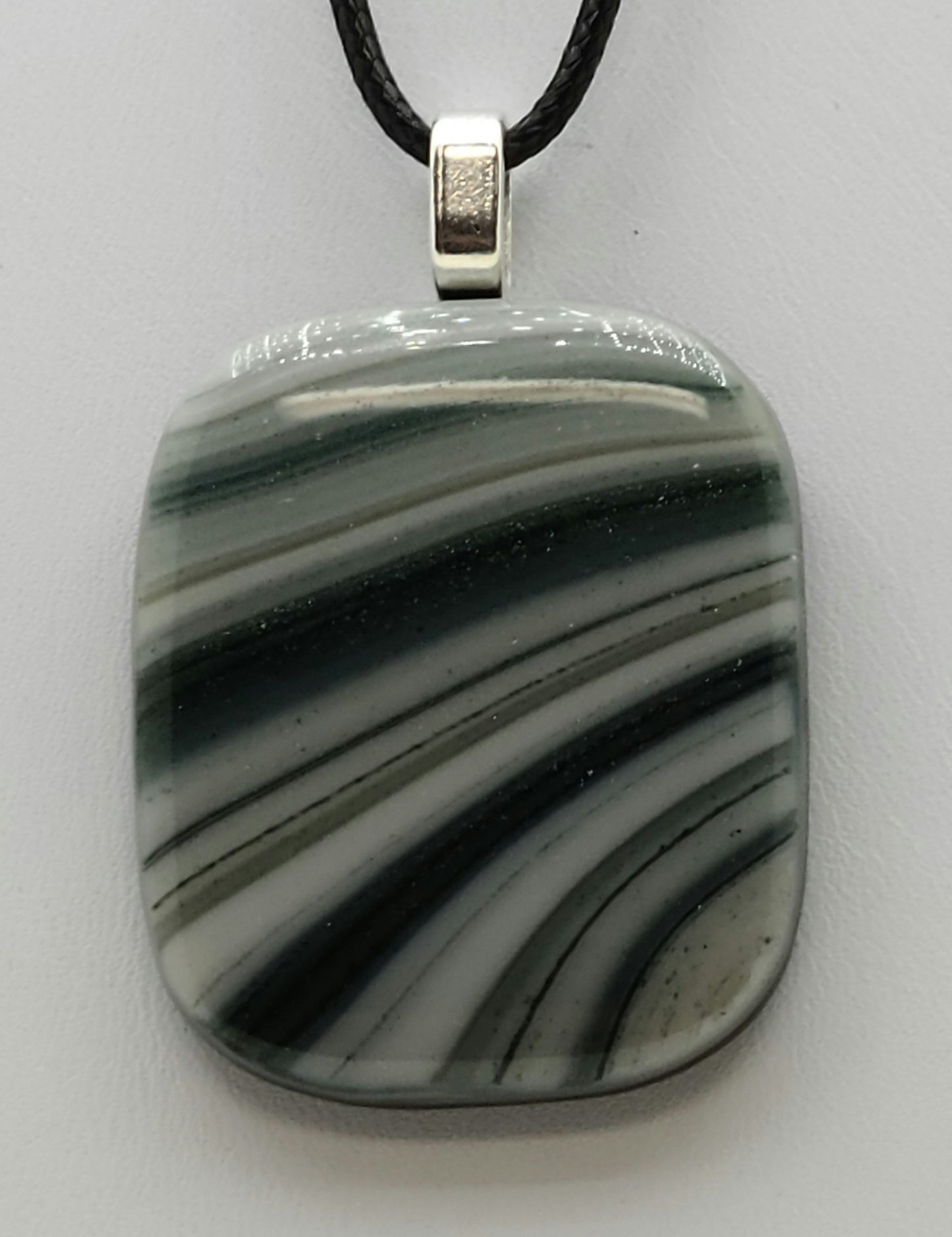 glittery green sweeps across this fused glass pendant.