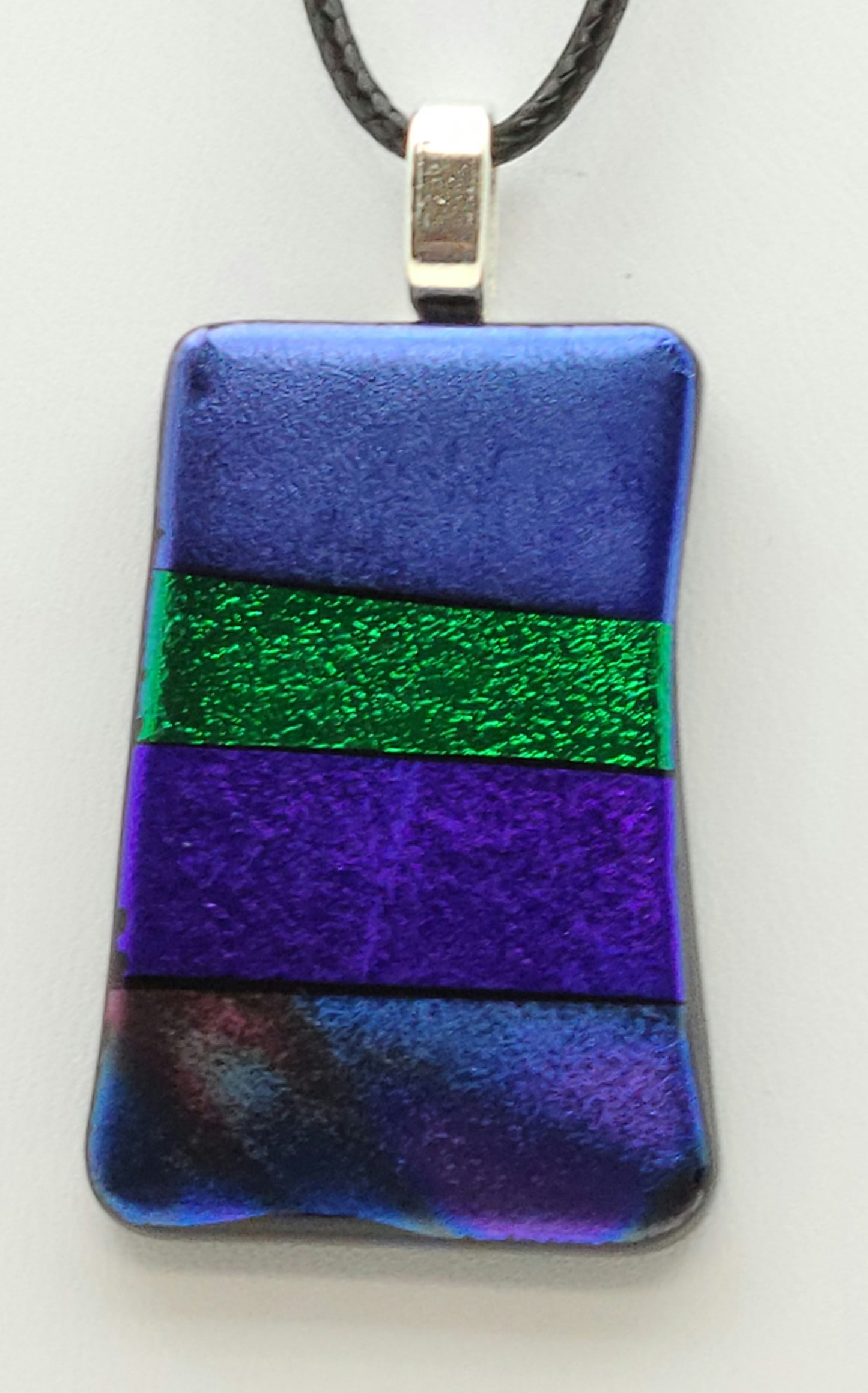 blue, green, purple, and mixed dichroic rows in this fused glass pendant.