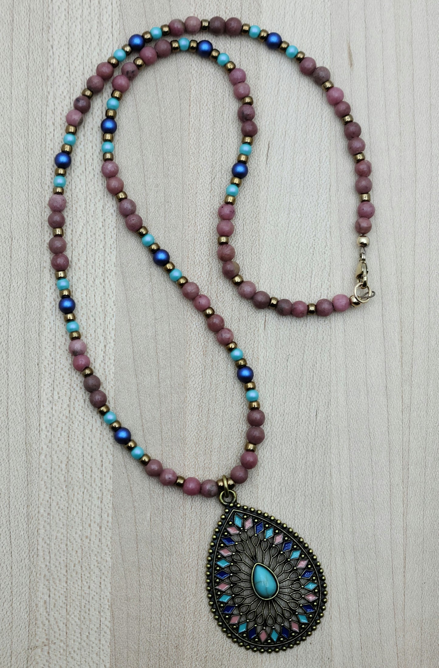 Brighten your day with this playful Pink/Blue/Turquoise Teardrop Necklace.