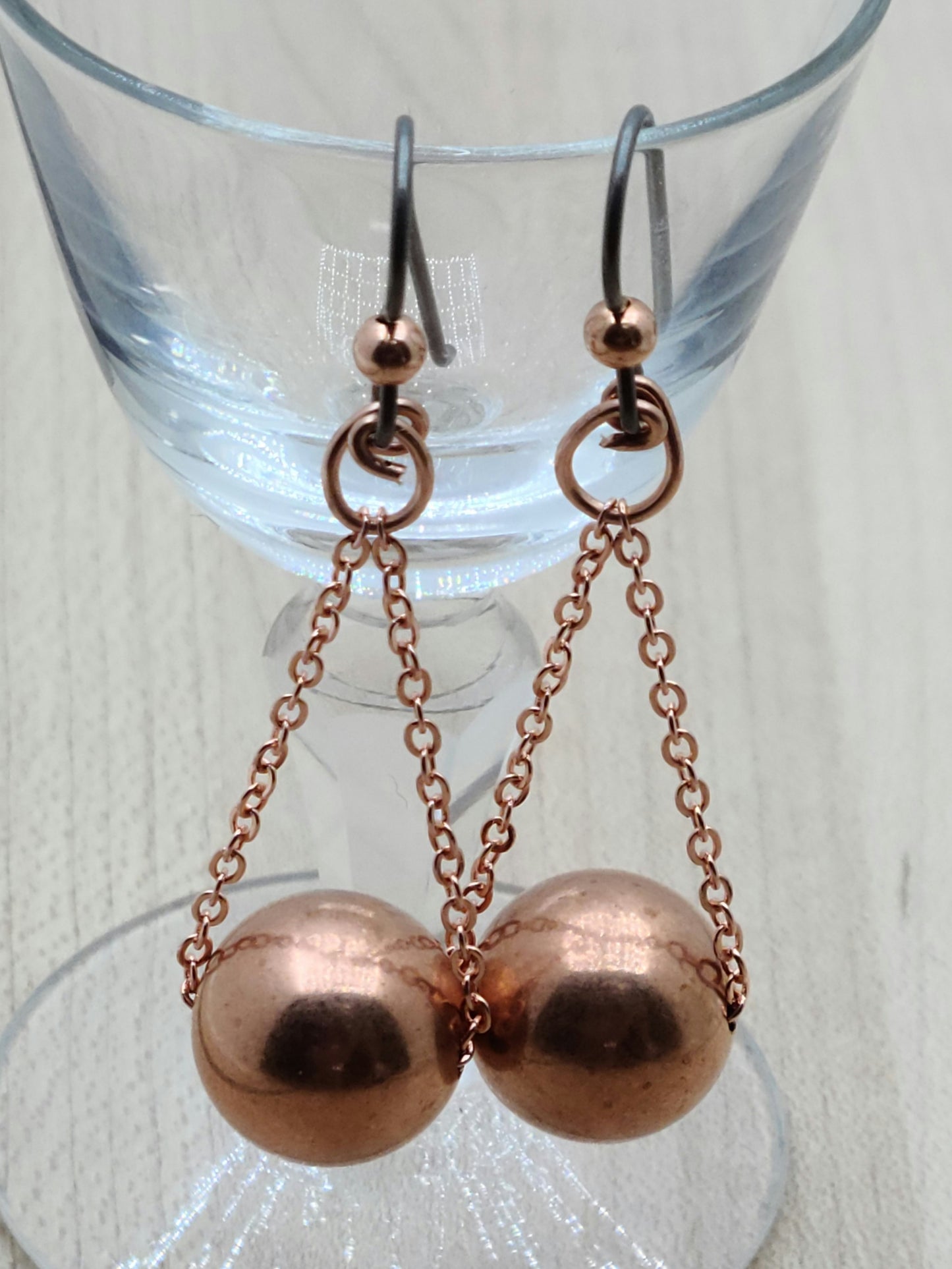 Add a pop of shine and fun to your look with these Copper Globes Earrings. Featuring large, bright copper balls that dance and catch the light, they hang effortlessly from delicate chains and copper wire. Finished with hypoallergenic niobium ear wires, they’re perfect for sensitive ears and guaranteed to spark smiles wherever you go.