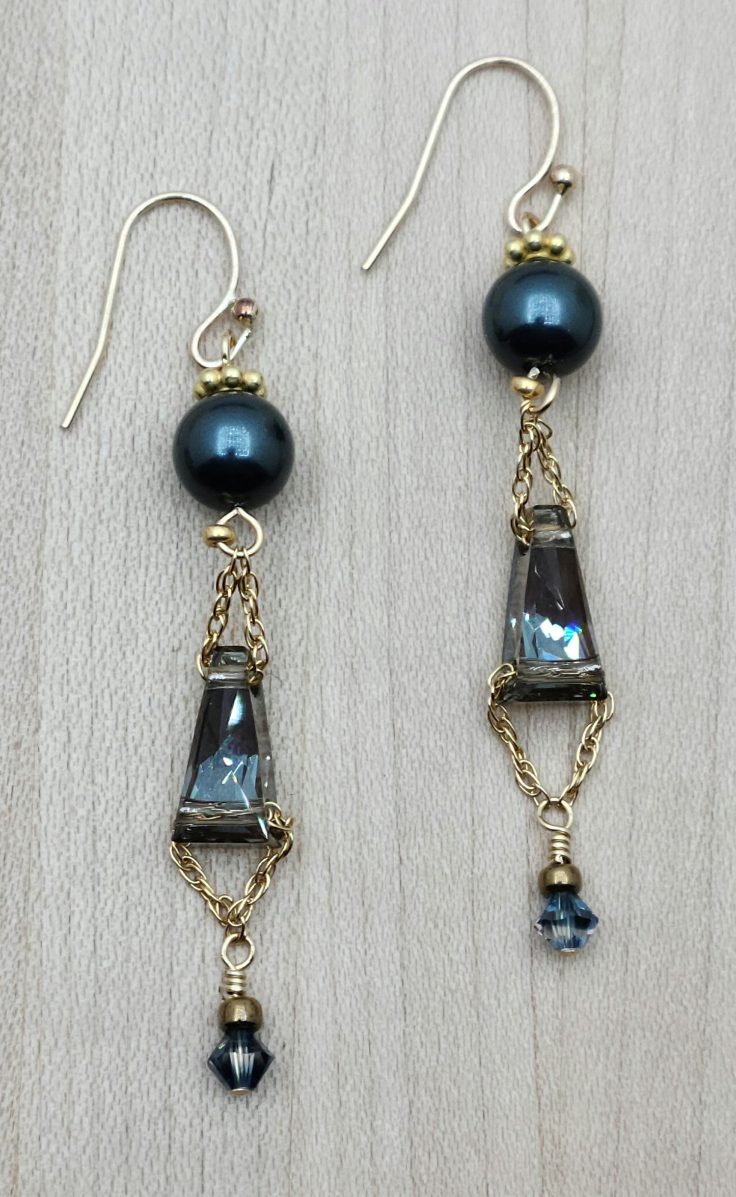 Beautiful blue/bronze keyhole crystals are featured in these earrings with gold filled chain & french hook ear wires.
