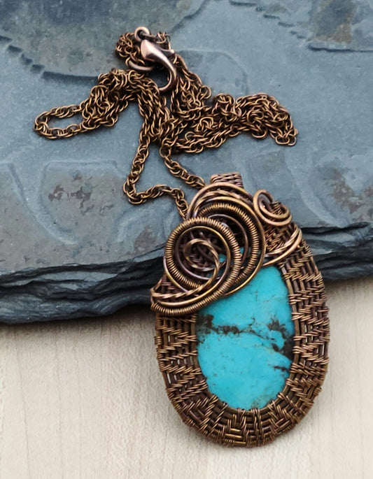 Chevrons & swirls of copper wire surround the lovely turquoise cabochon pendant.