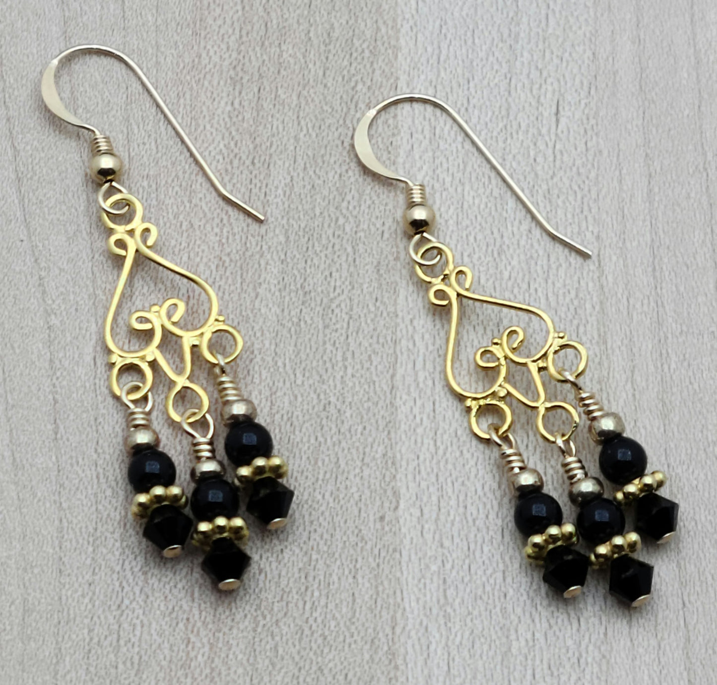 Gold Vermeil Chandeliers host dangles of black crystal pearls & black crystals in these earrings with gold filled fish hook earwires.