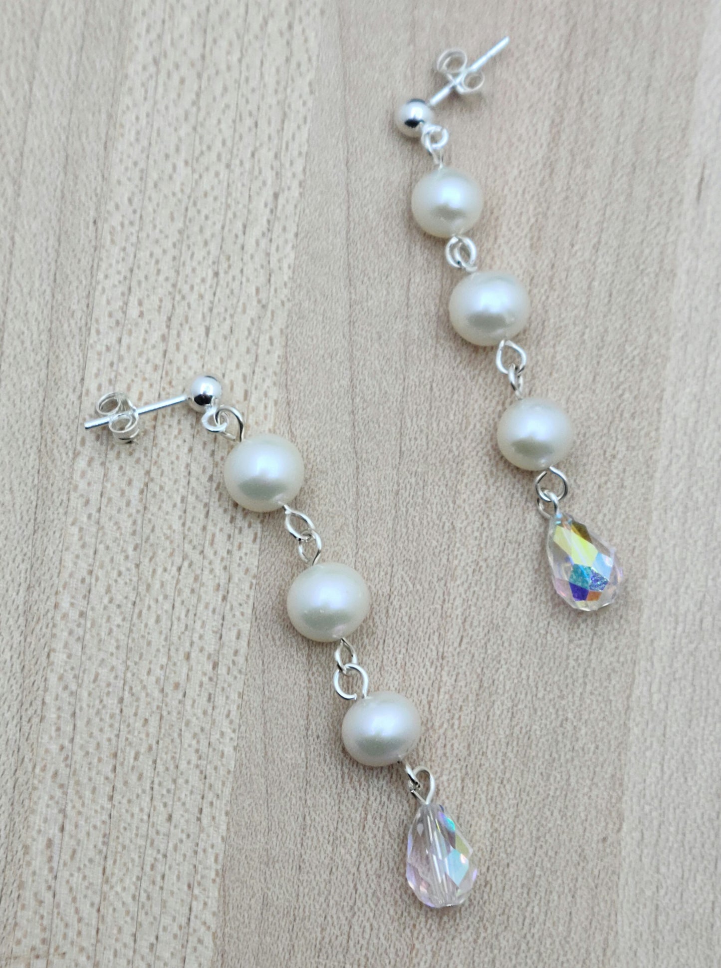 Freshwater pearls are SO classy. You'll love the movement and sparkle of this pair that joins pearls & aurora borealis teardrop crystals! 2" with sterling silver ball post earrings