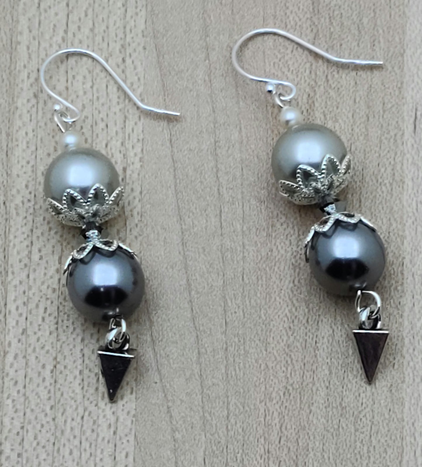 Shell pearl fish hook earrings terminated in silver pewter 'daggers'