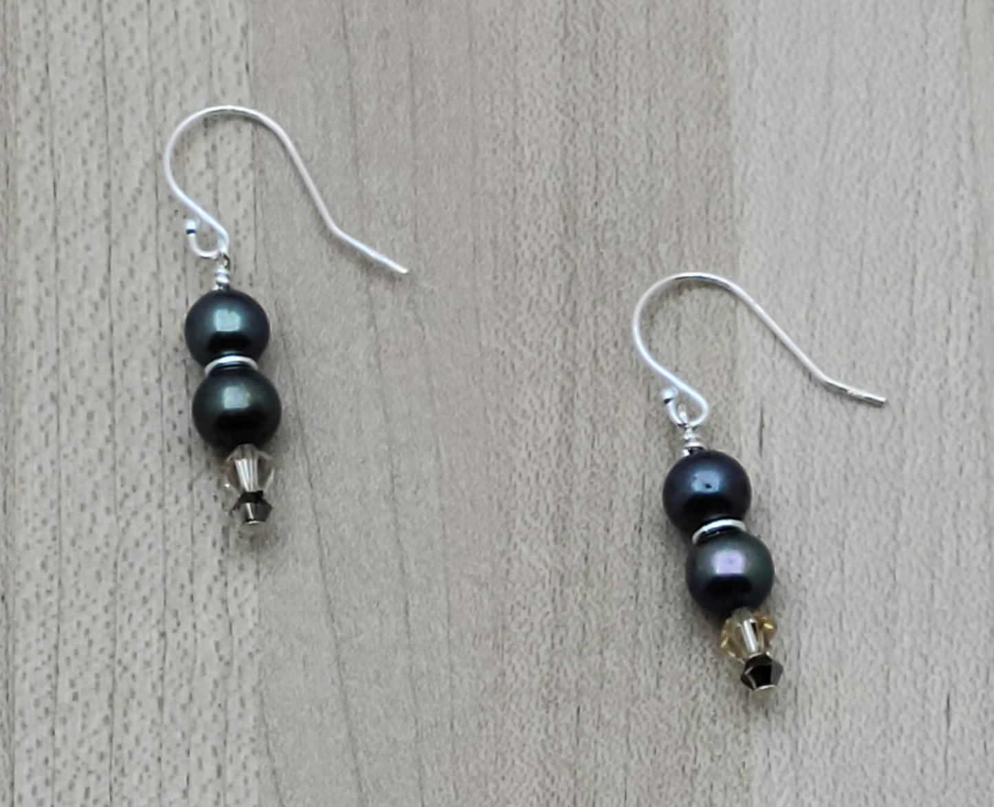 Black FW pearls and pale peach crystals make these dainty fish hook earrings.