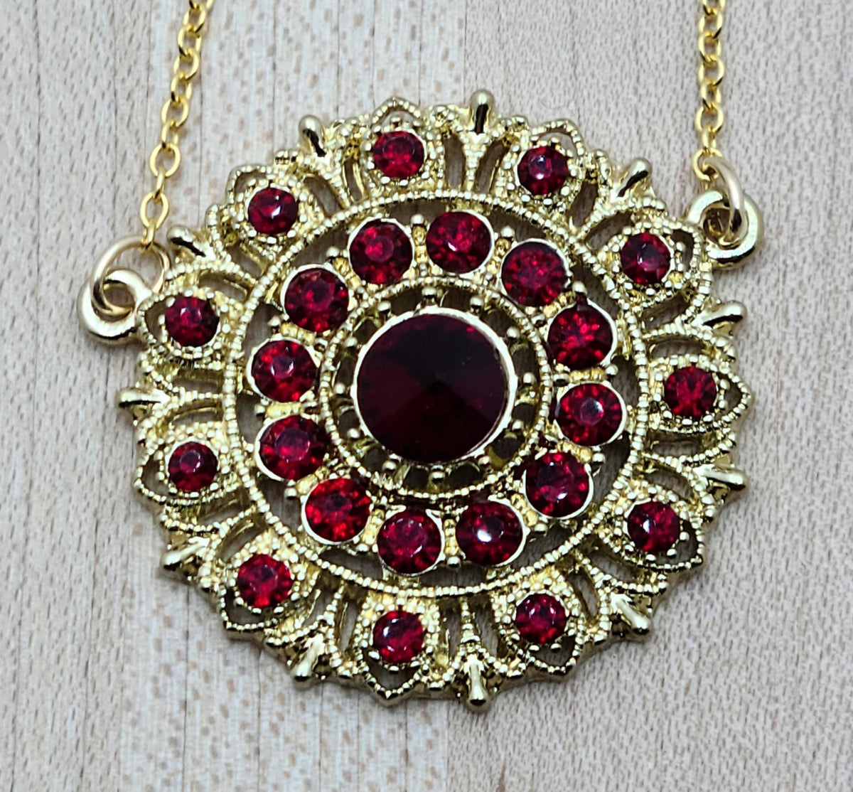 I found a gorgeous gold vintage scarlet crystal* encrusted medallion, added chain and earrings, and voila - a very striking set!