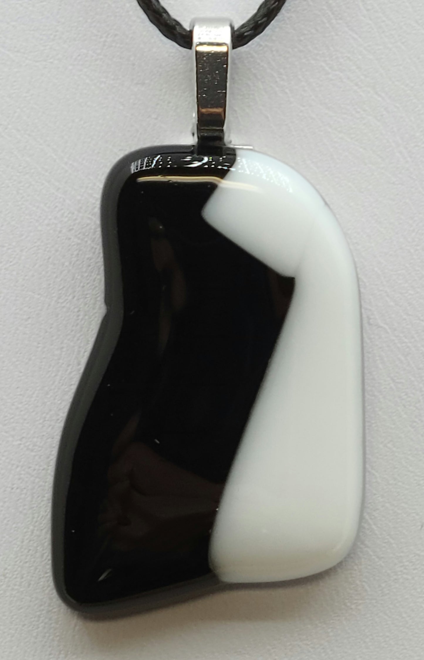 Add a modern twist to your outfit with this Black & White Zig-Zag Fused Glass Pendant.