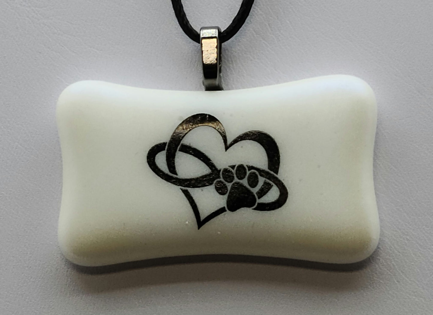 This dog bone shaped pendant will melt your heart with its trifecta of a paw print, infinity symbol, and heart.