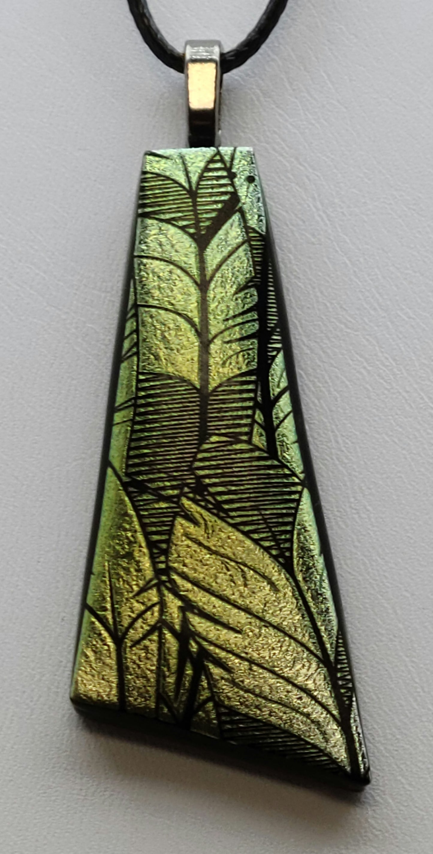 Unleash your inner free spirit with this Slender Feather Fused Glass Pendant.