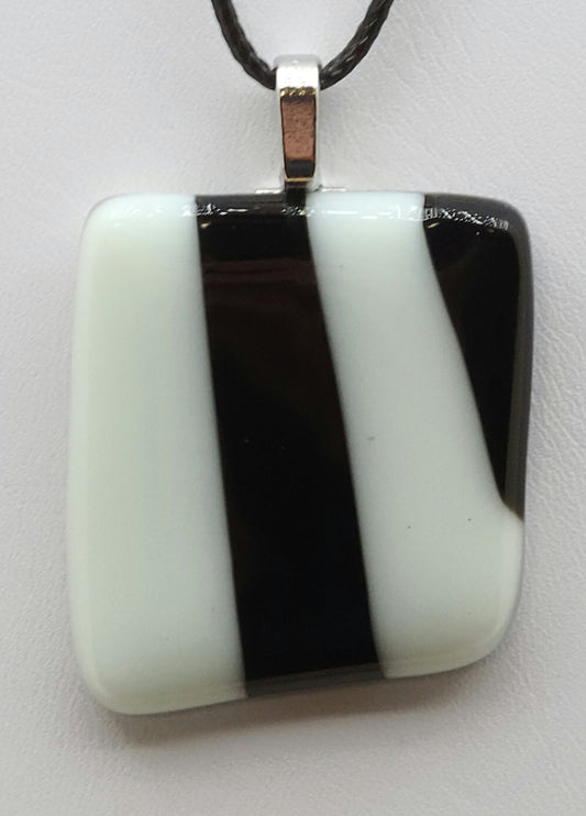 Add a touch of elegance to your wardrobe with our White w/Black Stripe Fused Glass Pendant.