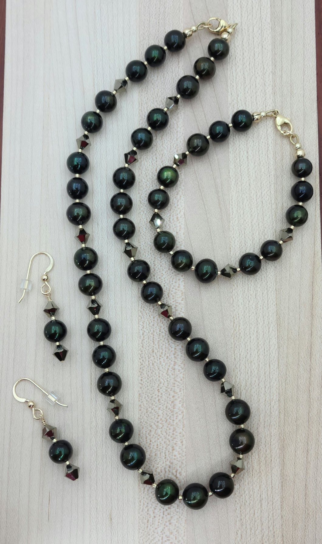 Very nice deep green pearls, aurum (latin for gold) crystals, champagne Miyuki delica, & gold filled findings necklace, bracelet, earrings