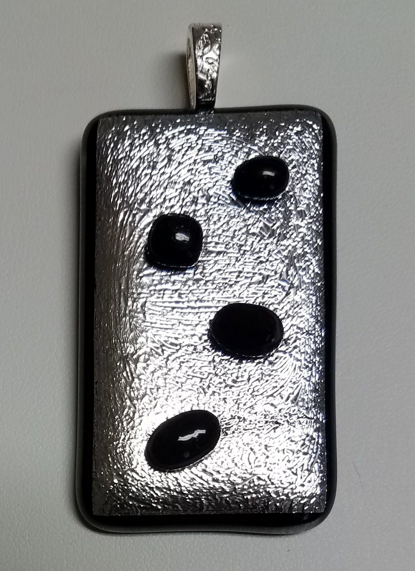 Black Pebbles of glass are tack fused to this silver crinkle dichroic.