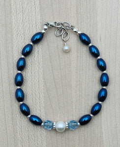Electroplated magnetic hematite in a deep iris blue pairs great with a white freshwater pearl and aquamarine crystals