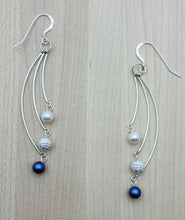 The iridescent dark blue crystal pearls & aurora borealis pave beads are exquisitely set off by white freshwater pearls in theses three bar dangle earrings!