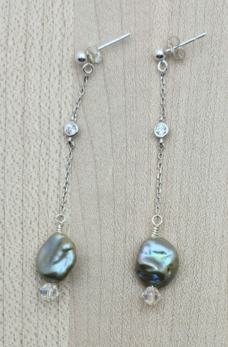 These lovely pistachio freshwater keshi pearls are accented with aurora borealis crystals & tiny cubic zirconia crystals enhance the chain.