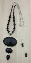 3 sizes of rhodium framed onyx are featured in the showpiece necklace! Also Onyx dangle earrings