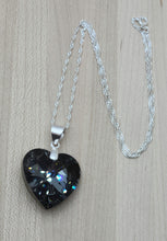 This beautiful crystal heart is a compliment to any attire and will always be admired! The focal is a large, dark grey, yet sparkling crystal heart pendant with sterling silver bail & chain.