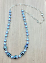 Iridescent light blue crystal pearls & light blue crystals fit perfectly with these beautiful tribal design etched crystal beads!   Necklace.