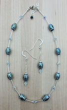 These beautiful tribal design etched crystal beads are set off with azure crystals* & liquid silver!  They're sure to garner attention when worn!  Necklace & earrings